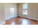 Spacious bedroom with hardwood floors, a white door, and a bright window at 238 N Main St, Wake Forest, NC 27587