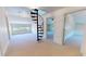 Large bonus room with spiral staircase, natural light, and multiple access doors at 238 N Main St, Wake Forest, NC 27587