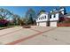 Spacious driveway featuring a central water fountain, with an adjacent three-car garage and well-maintained surroundings at 238 N Main St, Wake Forest, NC 27587