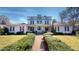 Charming two-story home featuring a manicured lawn, inviting walkway, and classic architectural details at 238 N Main St, Wake Forest, NC 27587