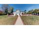 Grand home with multiple garages, brick accents, and manicured lawn at 238 N Main St, Wake Forest, NC 27587
