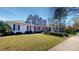 Elegant home with a manicured lawn and lush landscaping, showcasing its classic architecture and curb appeal at 238 N Main St, Wake Forest, NC 27587