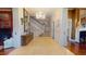 Elegant foyer featuring a grand staircase, chandelier, and tiled floor for a welcoming entrance at 238 N Main St, Wake Forest, NC 27587