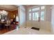 Elegant foyer with a chandelier, tile flooring, and detailed trim at 238 N Main St, Wake Forest, NC 27587