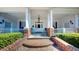 Inviting home entrance featuring columns, brick accents, and manicured landscaping at 238 N Main St, Wake Forest, NC 27587