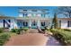 Stately home with a brick walkway leading to a grand covered porch with white columns and manicured landscaping at 238 N Main St, Wake Forest, NC 27587