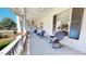 Charming front porch with rocking chairs, offering a cozy and inviting outdoor space to enjoy the surrounding views at 238 N Main St, Wake Forest, NC 27587
