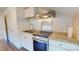 The kitchen features stainless appliances, granite countertops, and white cabinetry at 238 N Main St, Wake Forest, NC 27587