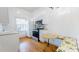 Efficient kitchen with white cabinets, stainless steel appliances, and a cozy breakfast nook at 238 N Main St, Wake Forest, NC 27587