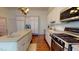 Modern kitchen featuring white cabinets, stainless steel appliances, and a large island at 238 N Main St, Wake Forest, NC 27587