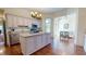 Open kitchen with custom cabinets, stainless steel appliances, and hardwood floors at 238 N Main St, Wake Forest, NC 27587