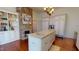 Bright kitchen with custom cabinets, stone fireplace, modern appliances, and hardwood floors at 238 N Main St, Wake Forest, NC 27587