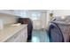 Laundry room featuring tile floors, cabinets and shelving, and side-by-side washer and dryer at 238 N Main St, Wake Forest, NC 27587