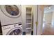 Convenient laundry area with stacked washer and dryer, plus built-in shelving at 238 N Main St, Wake Forest, NC 27587