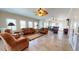 Large living room with tile floors and ceiling fans, open to a dining area with multiple windows at 238 N Main St, Wake Forest, NC 27587