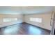 Bright living room with wood floors and windows overlooking the backyard area at 238 N Main St, Wake Forest, NC 27587