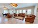 Spacious living room with tile floors, multiple windows, ceiling fans, and comfortable seating arrangement at 238 N Main St, Wake Forest, NC 27587