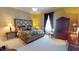 Comfortable main bedroom with a padded headboard, wardrobe, and blackout curtains at 238 N Main St, Wake Forest, NC 27587