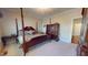 Main bedroom features a canopy bed with ornate furnishings, and plush carpeting at 238 N Main St, Wake Forest, NC 27587