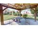 Covered patio with stone benches and table overlooking the backyard at 238 N Main St, Wake Forest, NC 27587