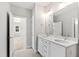 Bathroom with double vanity, framed mirror and access to another room at 2500 Everett Ave, Raleigh, NC 27607