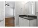 Bathroom featuring a grey vanity with a granite countertop and a large mirror at 2500 Everett Ave, Raleigh, NC 27607