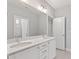 Bathroom features double vanity, framed mirror and neutral tiling at 2500 Everett Ave, Raleigh, NC 27607