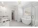 Spa-like bathroom featuring a soaking tub, stand-up shower, and granite countertop at 2500 Everett Ave, Raleigh, NC 27607