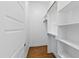 Spacious walk-in closet with built-in shelving and wooden rods for optimal storage solutions at 2500 Everett Ave, Raleigh, NC 27607