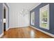 Dining room with gray walls, a modern chandelier, hardwood flooring, and abundant natural light at 2500 Everett Ave, Raleigh, NC 27607