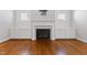 A fireplace with a decorative tile surround flanked by built-in cabinets and shiplap walls at 2500 Everett Ave, Raleigh, NC 27607
