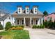 Charming home featuring dormer windows, stone accents, a well-manicured lawn, and a welcoming front porch at 2500 Everett Ave, Raleigh, NC 27607
