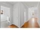 Hallway features hardwood floors, access to multiple rooms, and white trim at 2500 Everett Ave, Raleigh, NC 27607