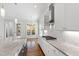 Bright kitchen boasts stainless appliances, white cabinets, granite counters and hardwood floors at 2500 Everett Ave, Raleigh, NC 27607