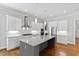 Open kitchen featuring stainless appliances, a large island, and granite countertops at 2500 Everett Ave, Raleigh, NC 27607