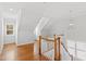 Upstairs landing featuring wood floors, staircase with white spindles and a chandelier at 2500 Everett Ave, Raleigh, NC 27607