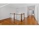 Hallway with wood floors, overhead lighting and stairs with white spindles at 2500 Everett Ave, Raleigh, NC 27607