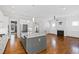 Open living space includes a kitchen island, fireplace, and hardwood floors at 2500 Everett Ave, Raleigh, NC 27607