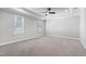 Large main bedroom features a ceiling fan, neutral carpet, and plenty of natural light at 2500 Everett Ave, Raleigh, NC 27607