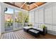 Screened-in porch with wicker furniture and wood paneled ceiling at 2500 Everett Ave, Raleigh, NC 27607