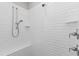 Bright shower features white subway tile, a built-in bench, and shower head at 2500 Everett Ave, Raleigh, NC 27607