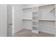 Bright walk-in closet with shelving and wooden racks offers ample storage at 2500 Everett Ave, Raleigh, NC 27607