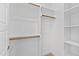Walk-in closet with wooden racks, shelves, and a neutral carpet at 2500 Everett Ave, Raleigh, NC 27607