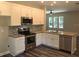 Spacious kitchen with stainless steel appliances, granite countertops, backsplash and white cabinets at 2600 Fayetteville St, Durham, NC 27707