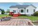 Expansive backyard with a brick patio, a vibrant garden, and scenic house views in a parklike setting at 2709 White Rail Dr, Fuquay Varina, NC 27526