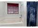 Bathroom featuring a soaking tub and decorative shower curtain at 2709 White Rail Dr, Fuquay Varina, NC 27526