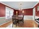Formal dining room featuring hardwood floors, elegant chandelier, and a classic grandfather clock at 2709 White Rail Dr, Fuquay Varina, NC 27526