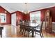 Formal dining room with hardwood floors, large windows, chandelier, and classic wooden furniture at 2709 White Rail Dr, Fuquay Varina, NC 27526