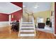 Spacious foyer featuring hardwood floors, staircase, piano, and an open view to the living room at 2709 White Rail Dr, Fuquay Varina, NC 27526