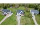 Aerial view of a home with well-maintained lawn, lengthy driveway, and a convenient two-car garage at 2709 White Rail Dr, Fuquay Varina, NC 27526